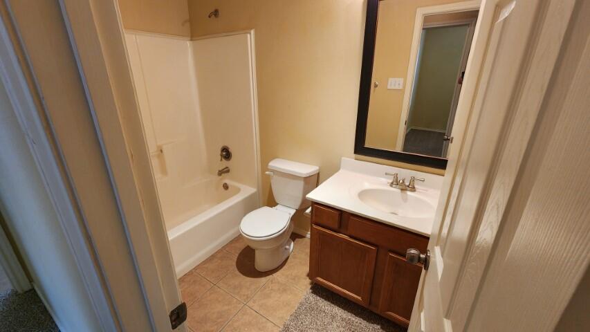 6535 93rd Street Lubbock, TX 79424 - Photo 6 of 13 a bathroom with a sink a toilet and a mirror