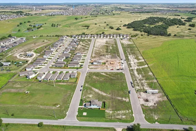 an aerial view of a residential houses with outdoor space