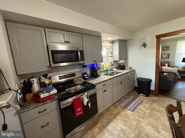 a kitchen with a sink appliances and cabinets