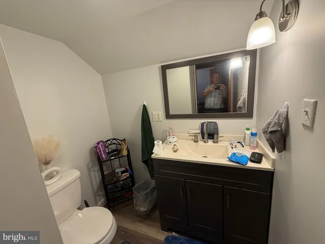 a bathroom with a toilet sink and mirror