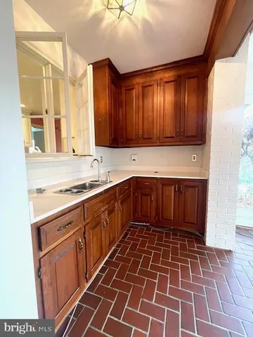 a kitchen with a sink a stove a microwave and cabinets