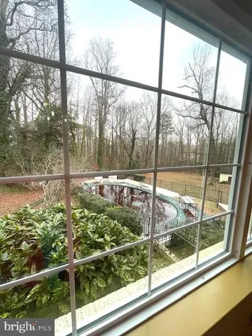 a large white kitchen with a large window