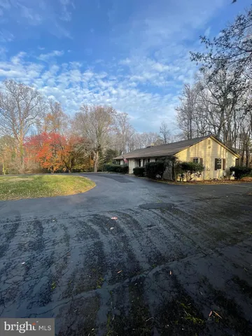 a view of a house with a swimming pool and sitting area