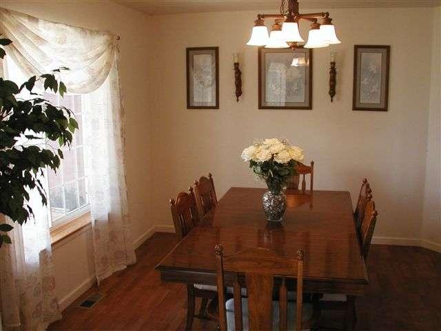 1318 West Spruce Court Rifle, CO 81650 - Photo 4 of 4 a view of a dining room with furniture and wooden floor