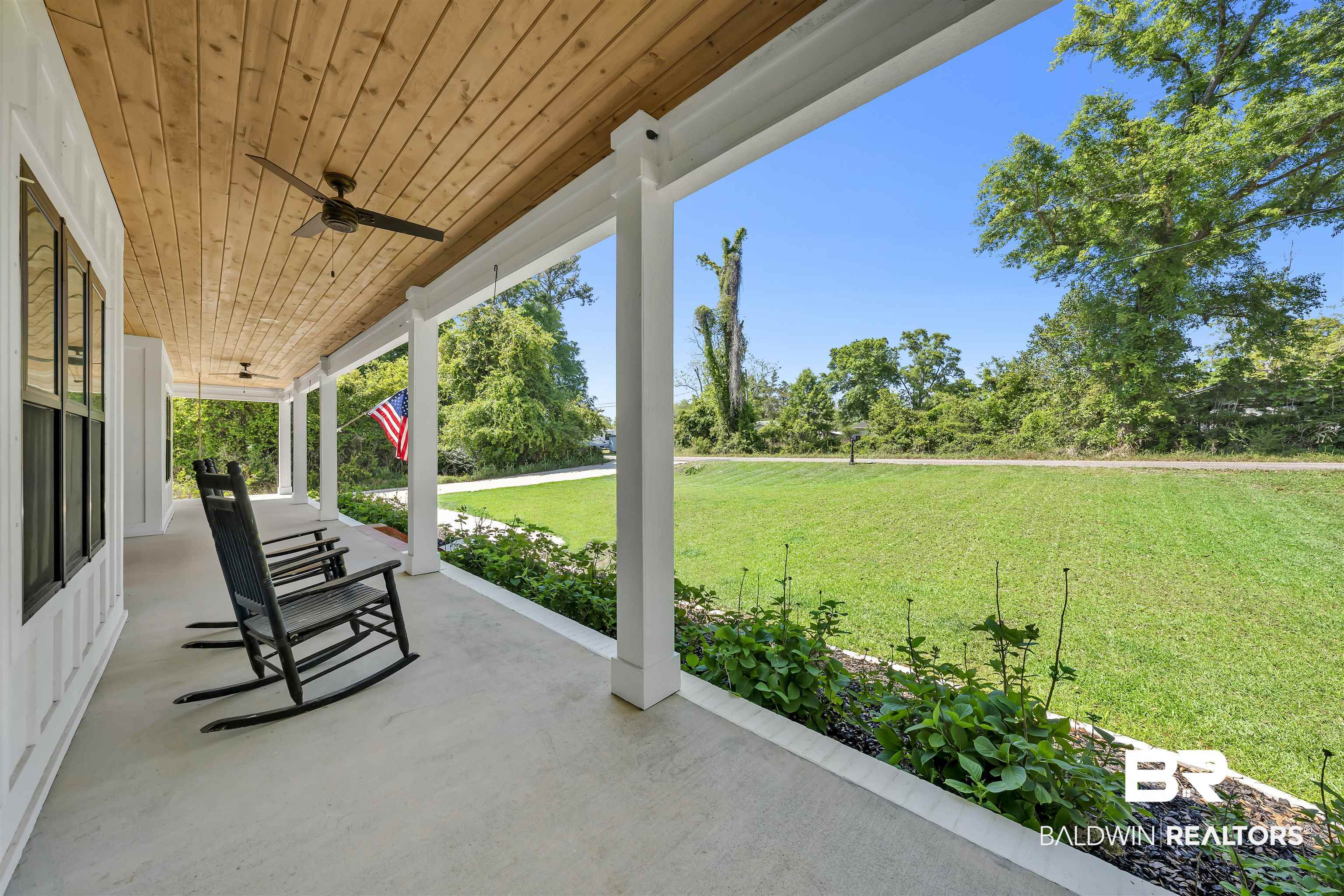 19058 James Road Gulf Shores, AL 36542 - Photo 3 of 49 Covered porch with a lawn and ceiling fan