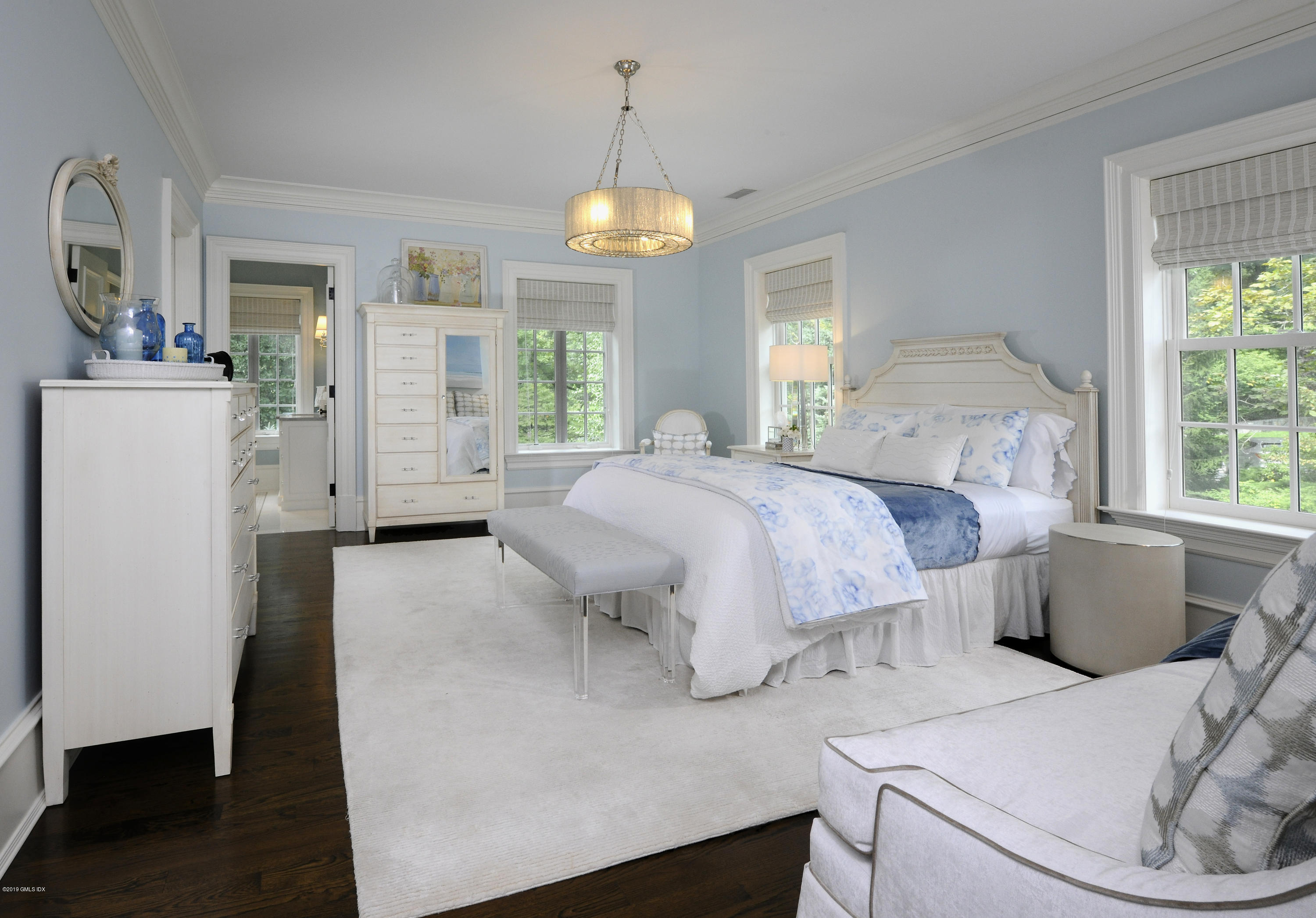 22 Cornelia Drive Greenwich, CT 06830 - Photo 16 of 34 a bedroom with a bed and a chandelier