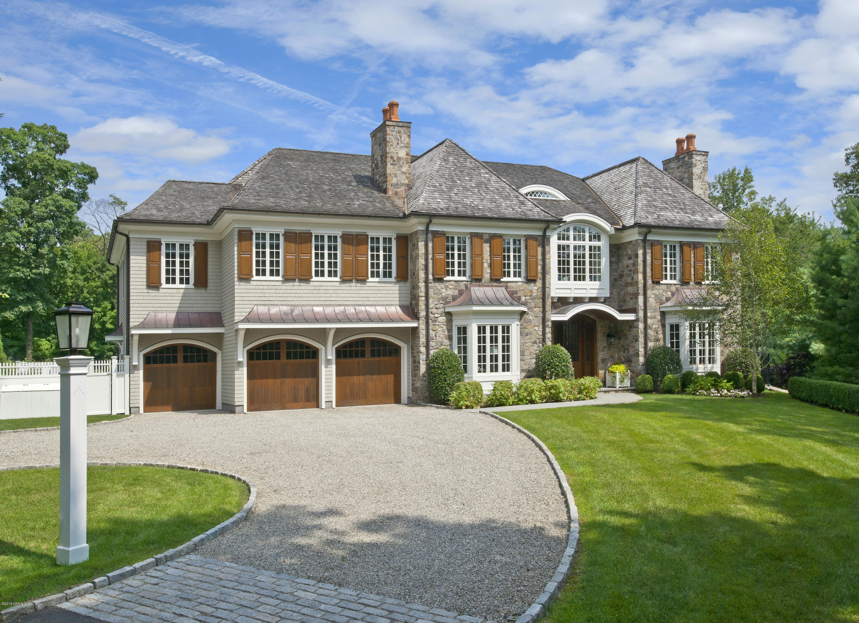 22 Cornelia Drive Greenwich, CT 06830 - Photo 2 of 34 a front view of a house with a yard