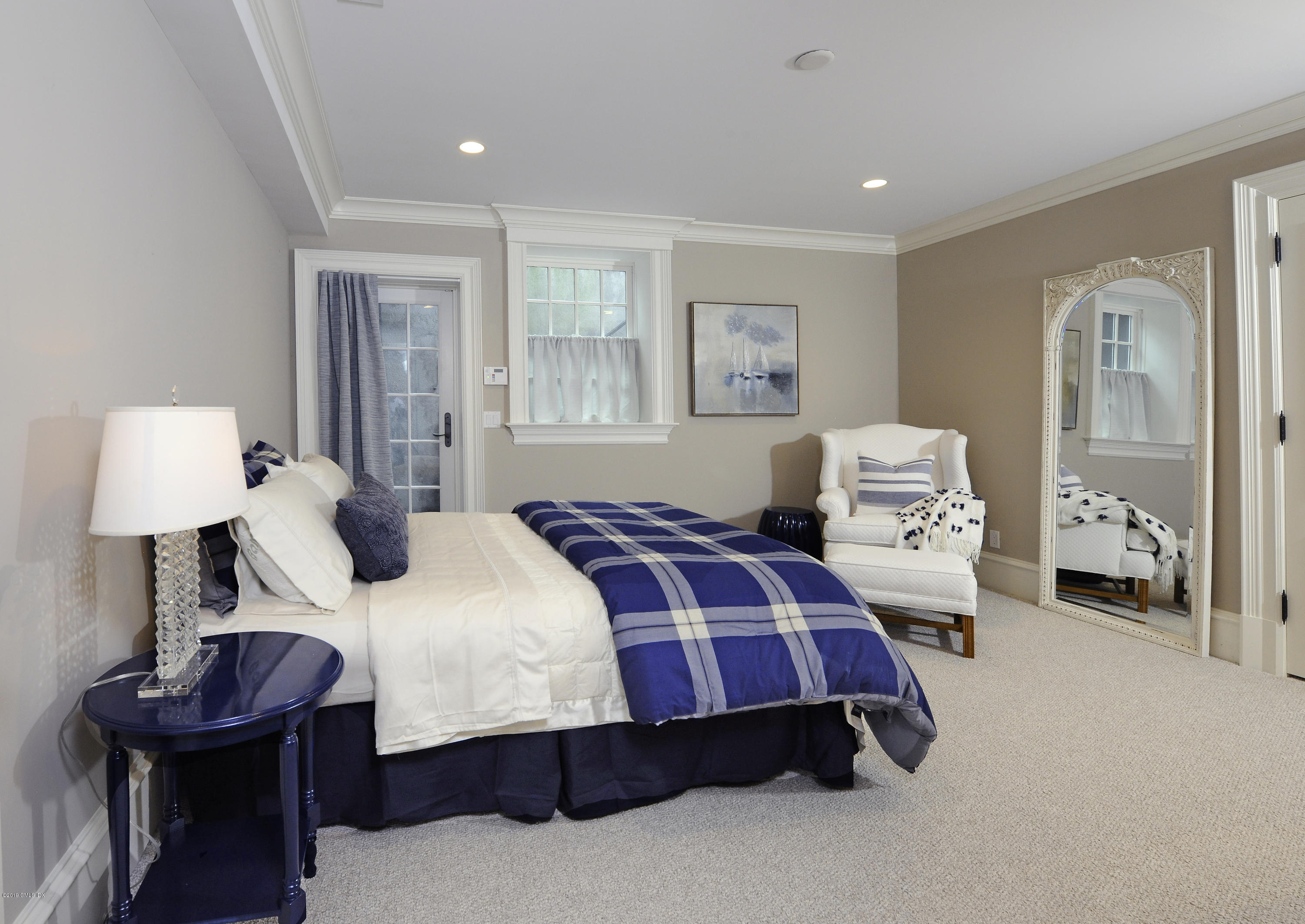 22 Cornelia Drive Greenwich, CT 06830 - Photo 29 of 34 a bed room with a bed and a lamp