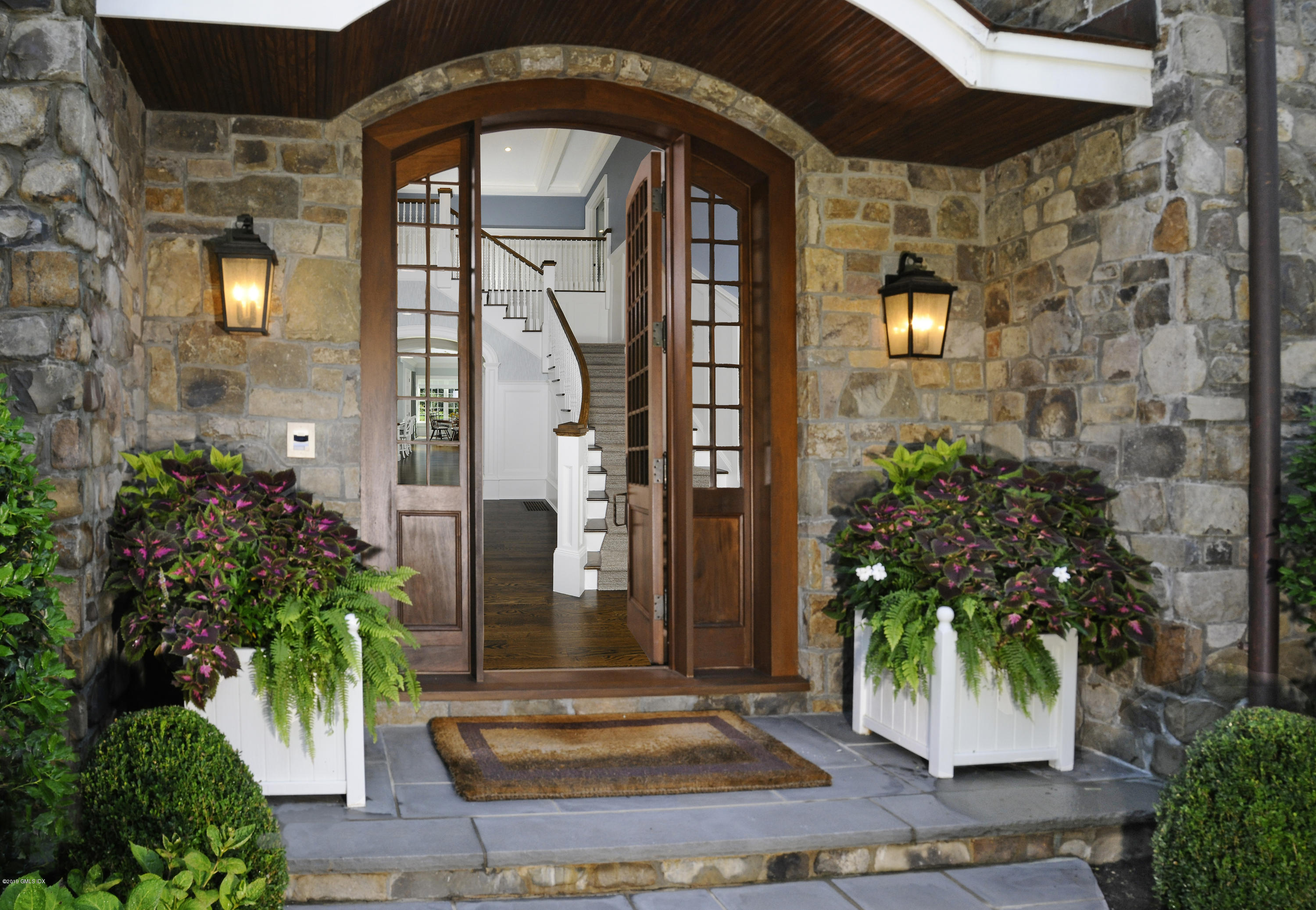 22 Cornelia Drive Greenwich, CT 06830 - Photo 3 of 34 a front view of a house with garden