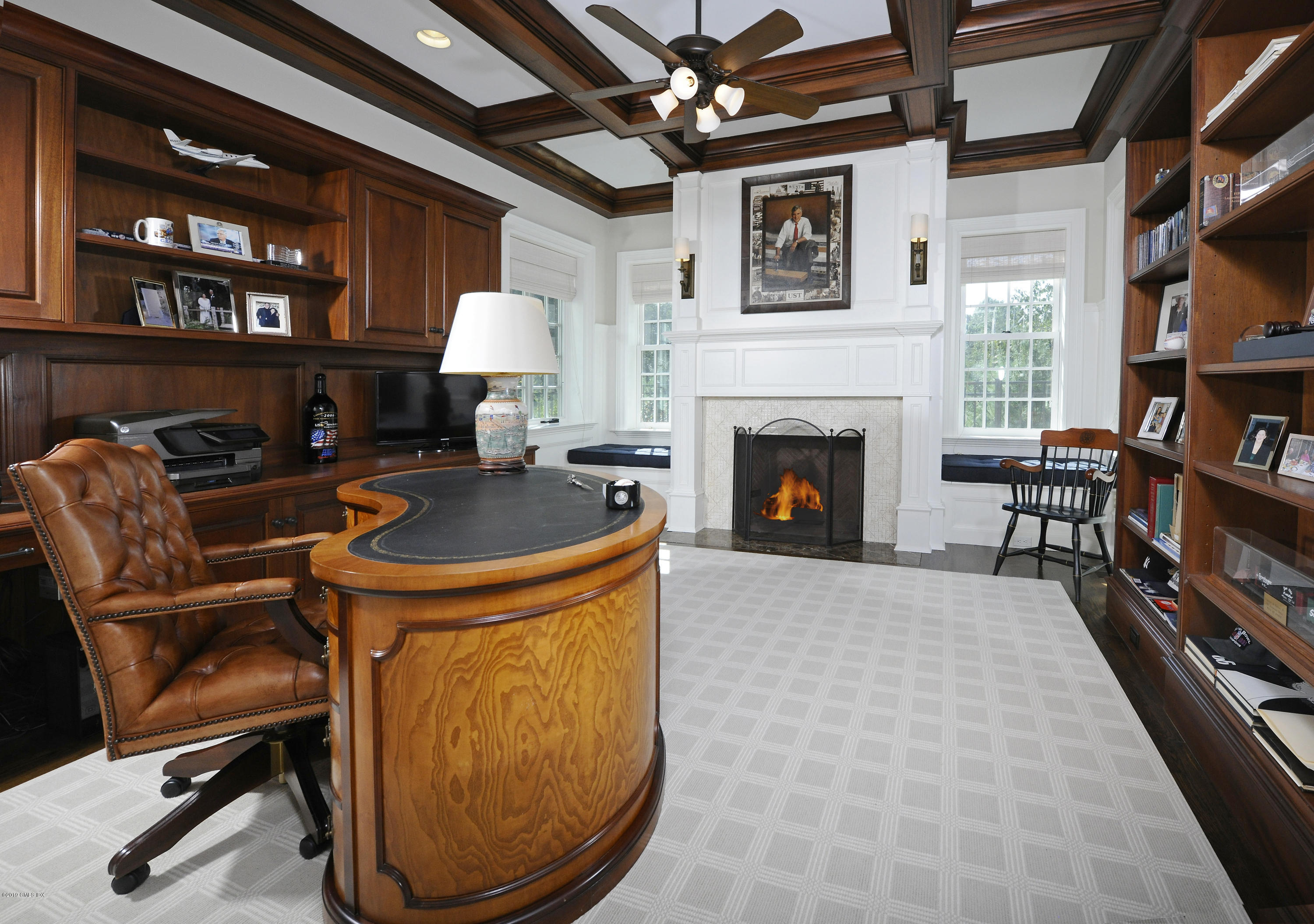 22 Cornelia Drive Greenwich, CT 06830 - Photo 10 of 34 a living room with furniture a fireplace and a bookshelf