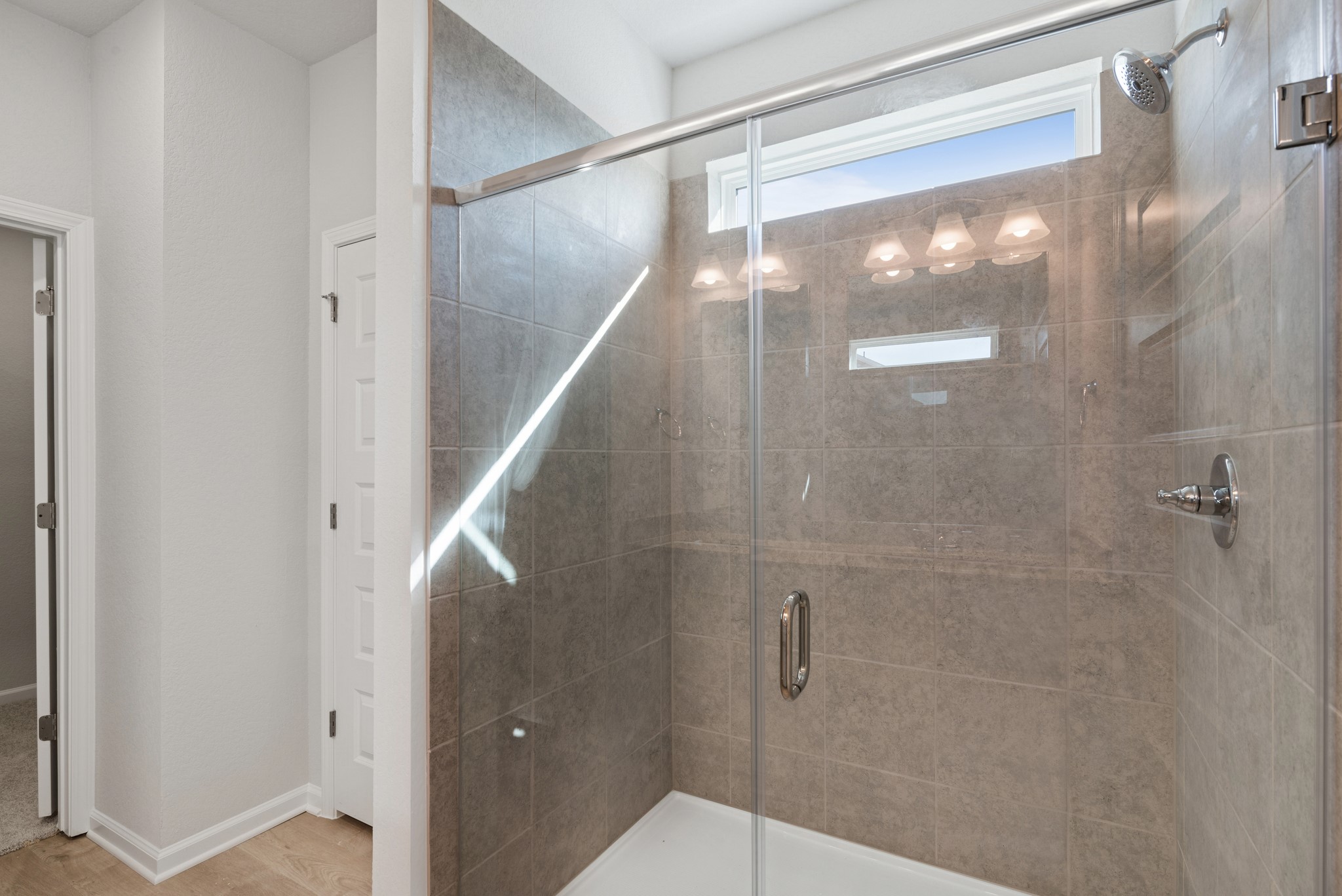 9761 Enclave Ridge Road Willis, TX 77318 - Photo 14 of 28 a bathroom with a glass shower door and a glass door