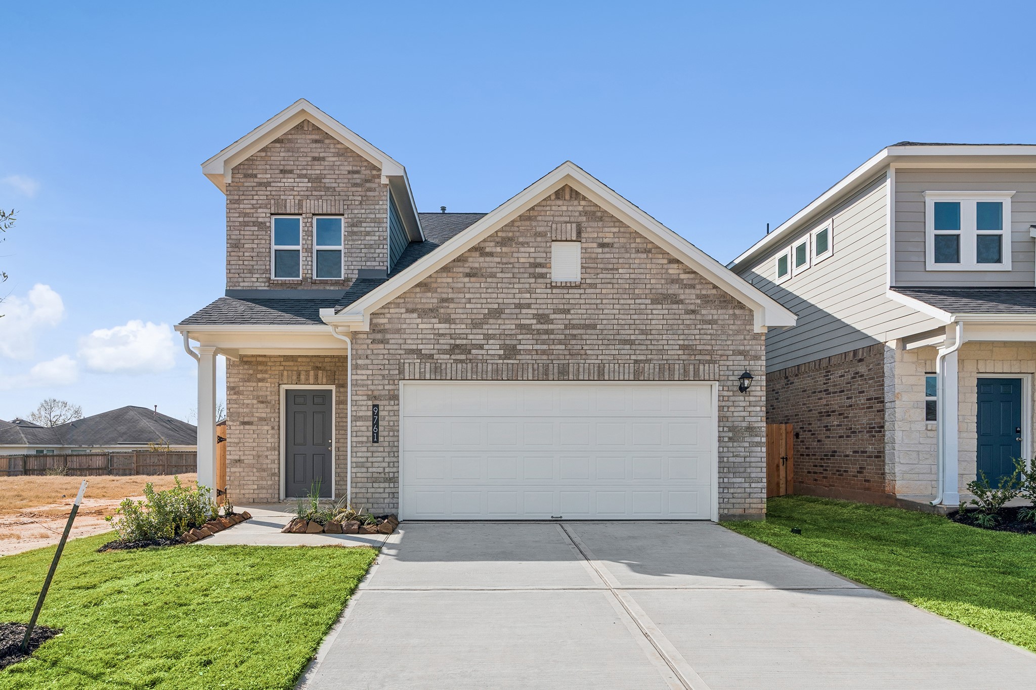 9761 Enclave Ridge Road Willis, TX 77318 - Photo 2 of 28 a front view of a house with a yard and garage