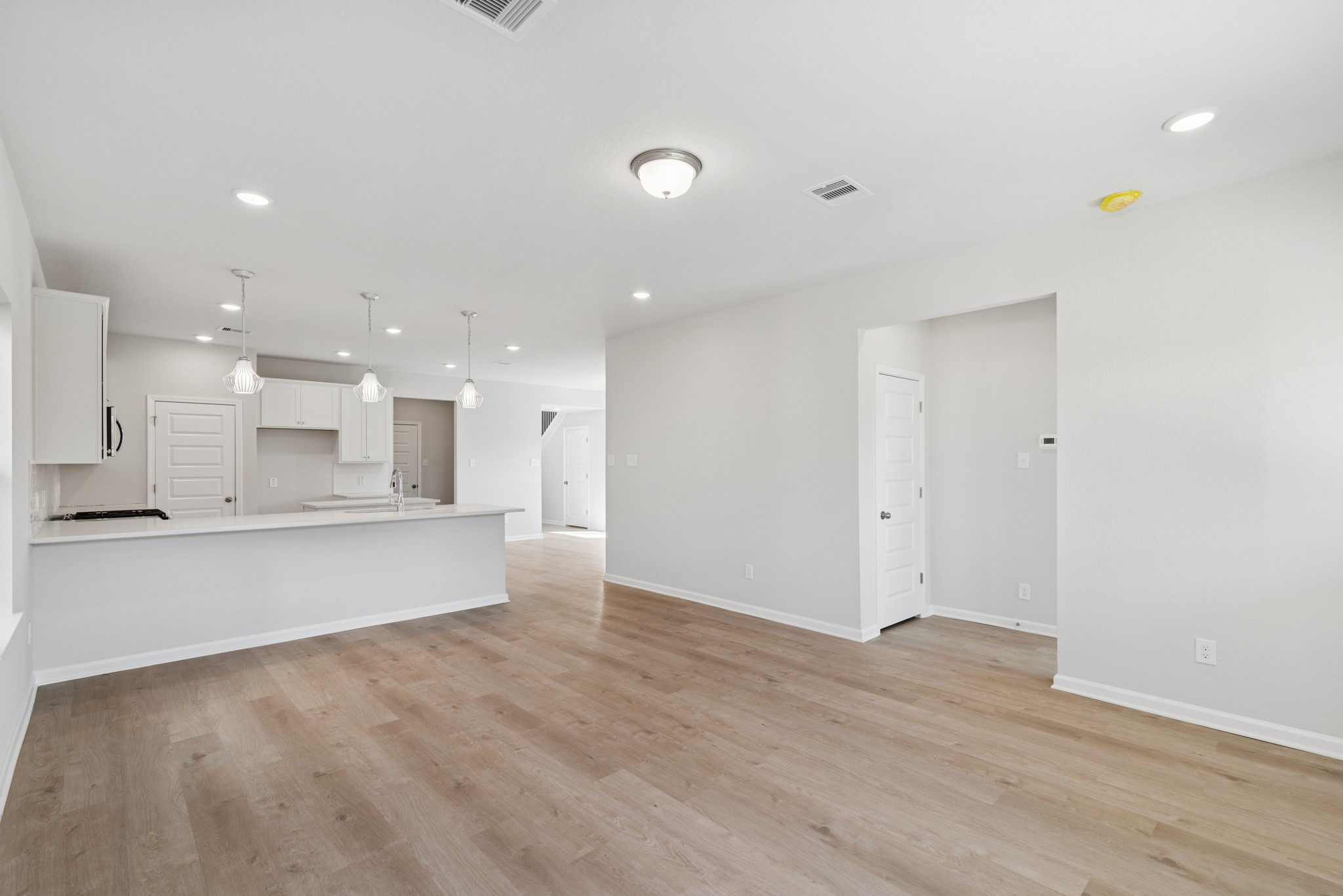 9761 Enclave Ridge Road Willis, TX 77318 - Photo 10 of 28 a view of kitchen with kitchen island sink and living room