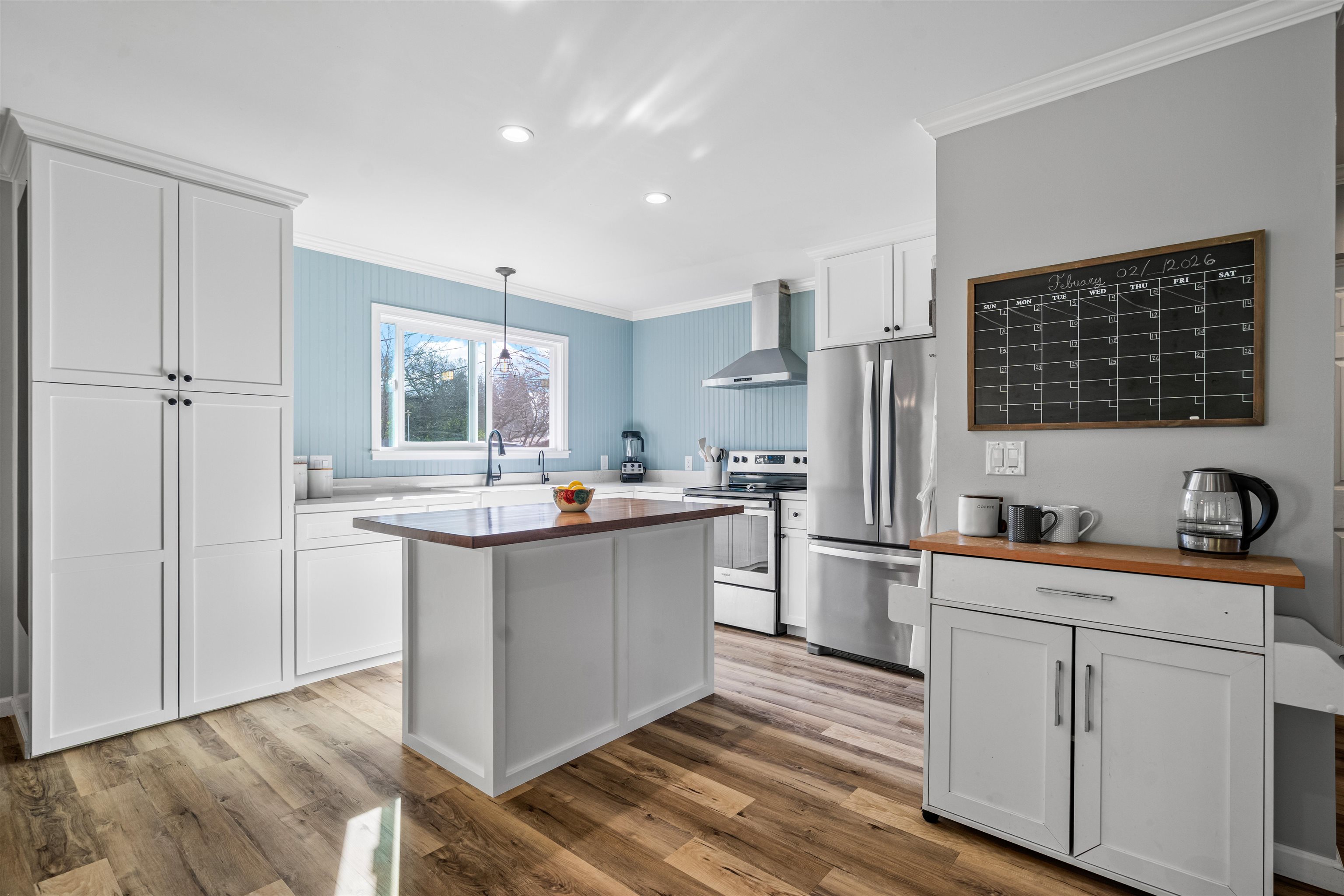 3281 Dunn Road Valley Springs, CA 95252 - Photo 12 of 59 Kitchen featuring wooden counters, crown molding, stainless steel appliances, white cabinetry, and pendant lighting