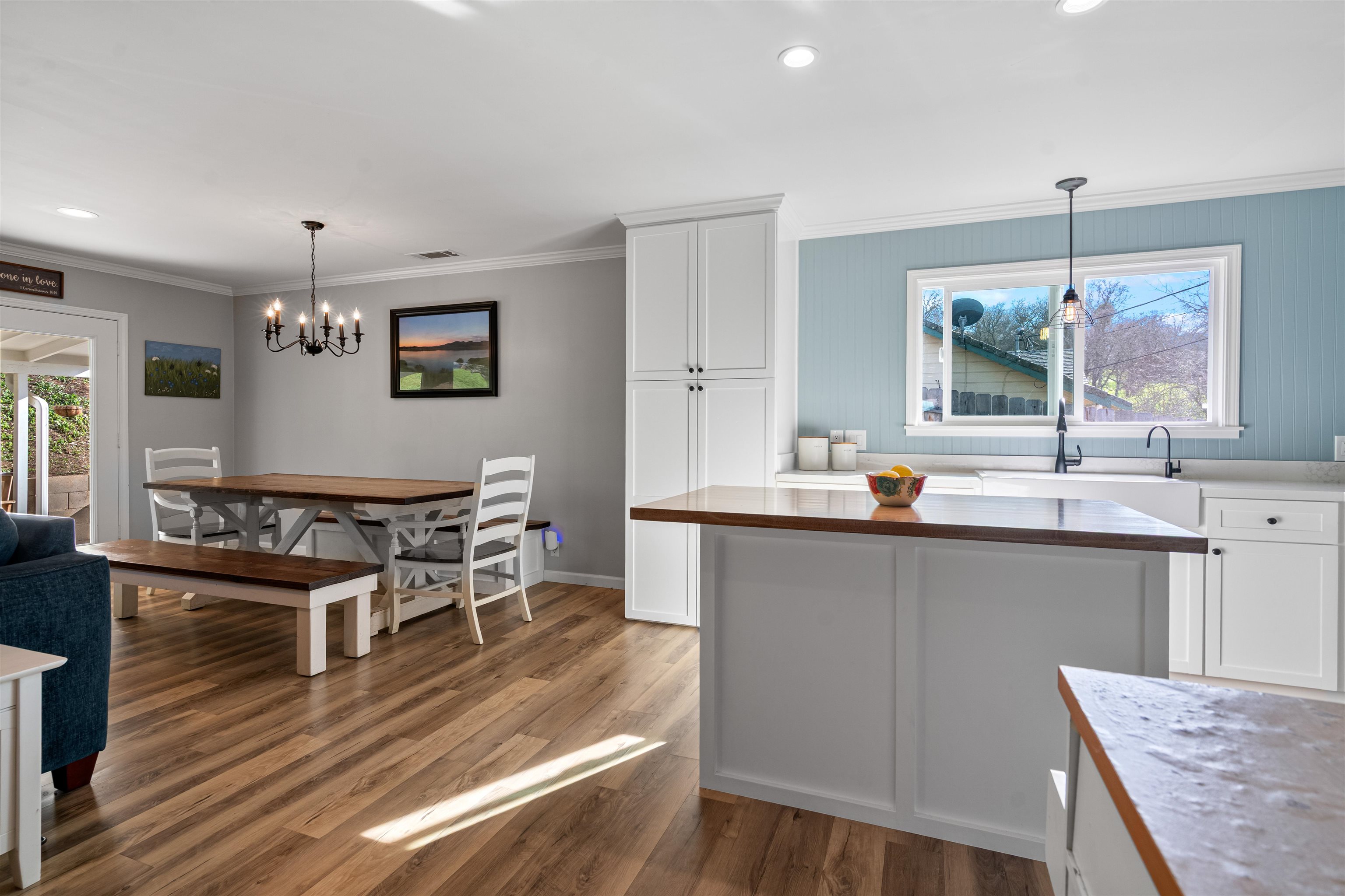 3281 Dunn Road Valley Springs, CA 95252 - Photo 16 of 59 Kitchen featuring white cabinetry, wooden counters, crown molding, light wood finished floors, and a kitchen island