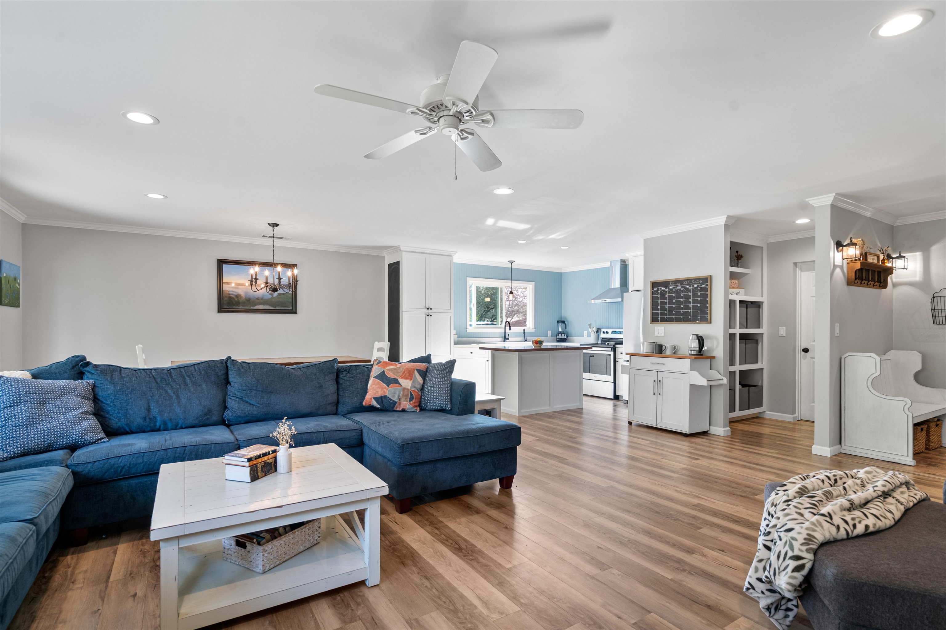 3281 Dunn Road Valley Springs, CA 95252 - Photo 18 of 59 Living room with crown molding, ceiling fan, hanging lights, and light wood-type flooring