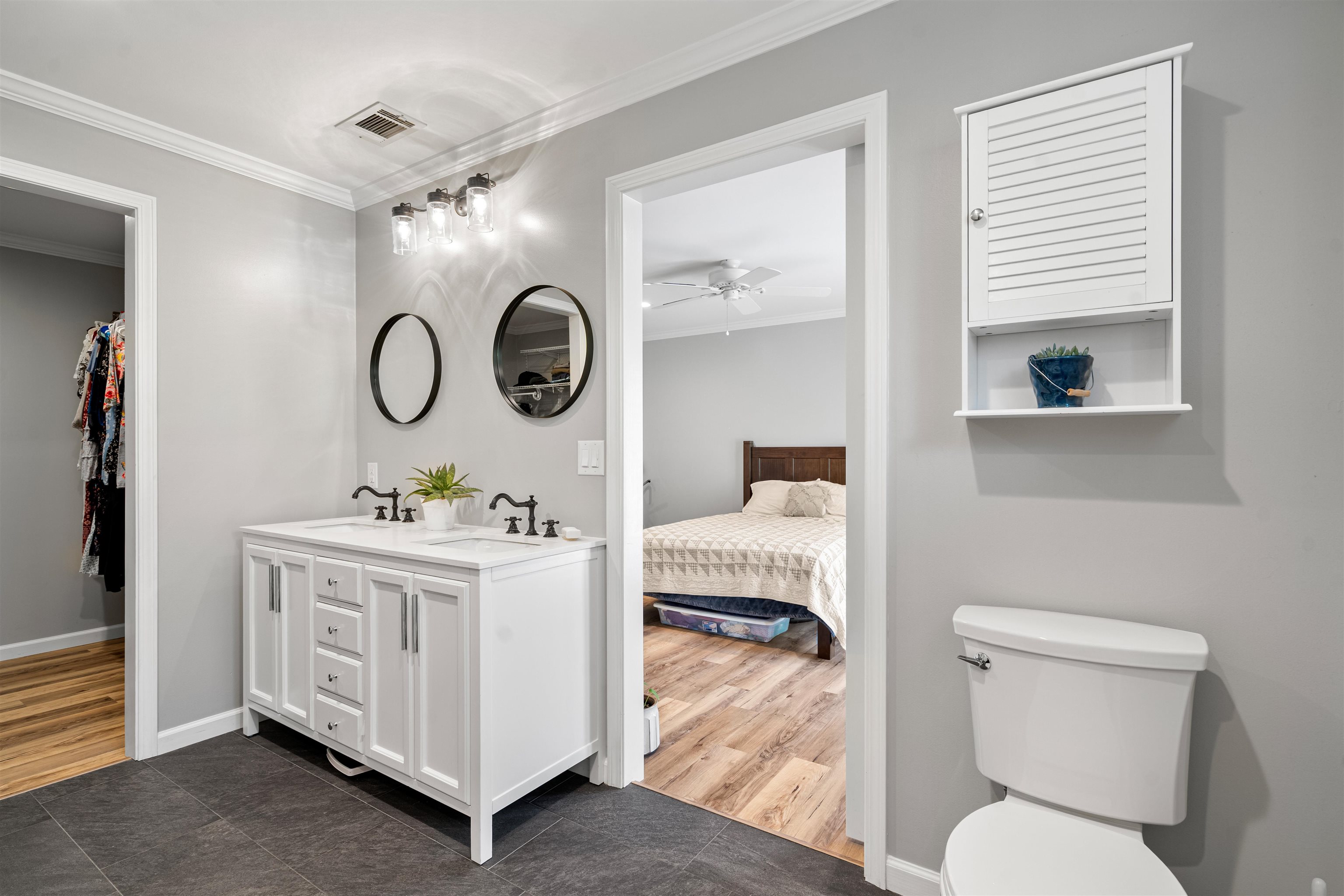 3281 Dunn Road Valley Springs, CA 95252 - Photo 33 of 59 Bathroom featuring ornamental molding, double vanity, ensuite bath, dark tile patterned floors, and a walk in closet