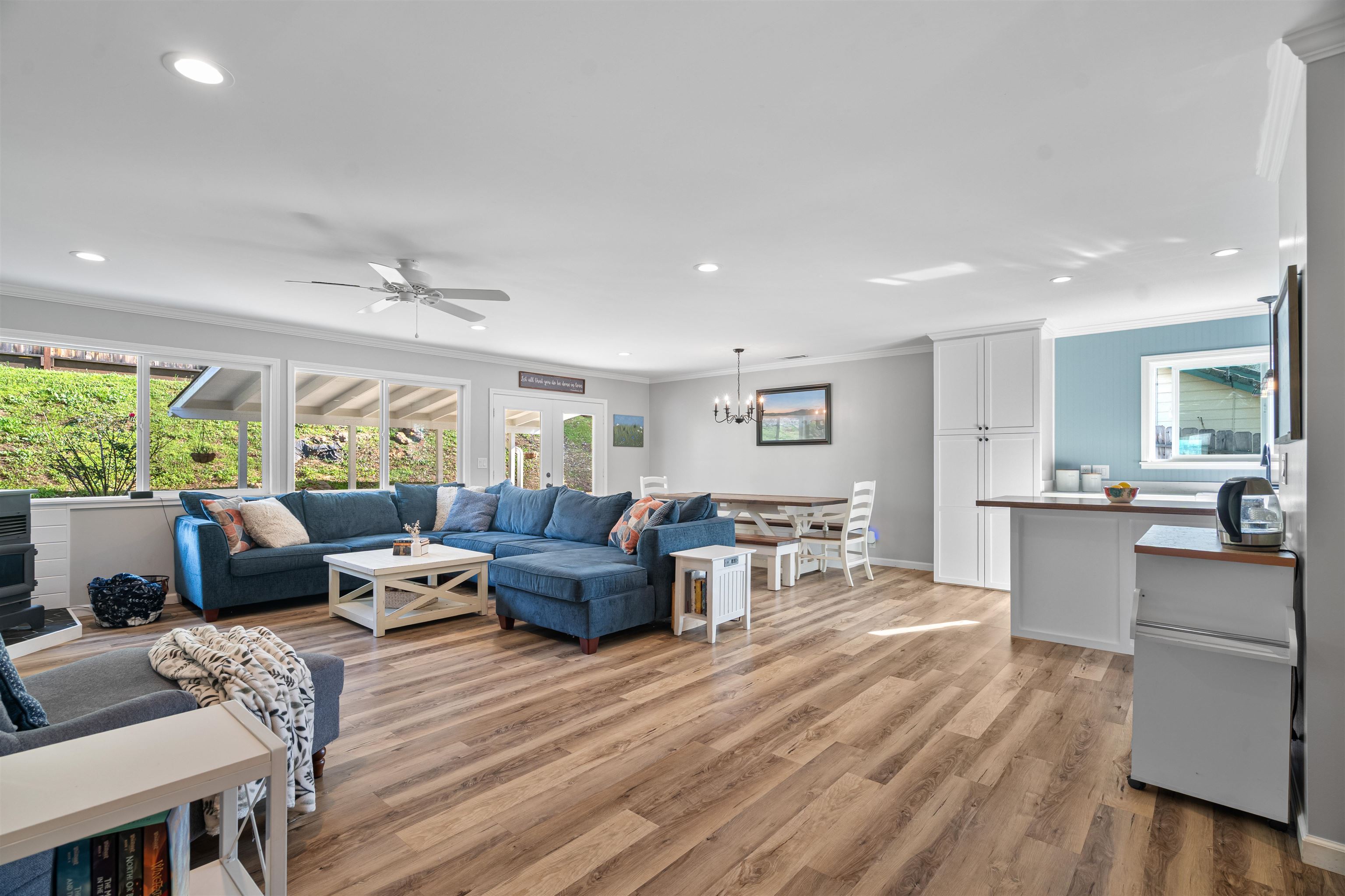 3281 Dunn Road Valley Springs, CA 95252 - Photo 8 of 59 Living room featuring ornamental molding, light wood-style flooring, a ceiling fan, and hanging lights