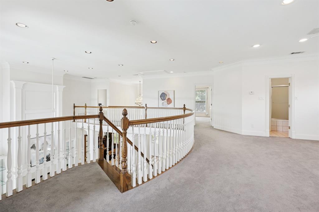 6065 Dilbeck Lane Dallas, TX 75240 - Photo 24 of 40 a view of a hallway with bedroom