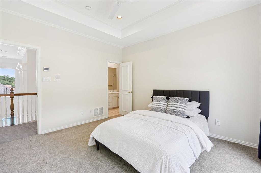 6065 Dilbeck Lane Dallas, TX 75240 - Photo 27 of 40 a bedroom with a bed and a night stand