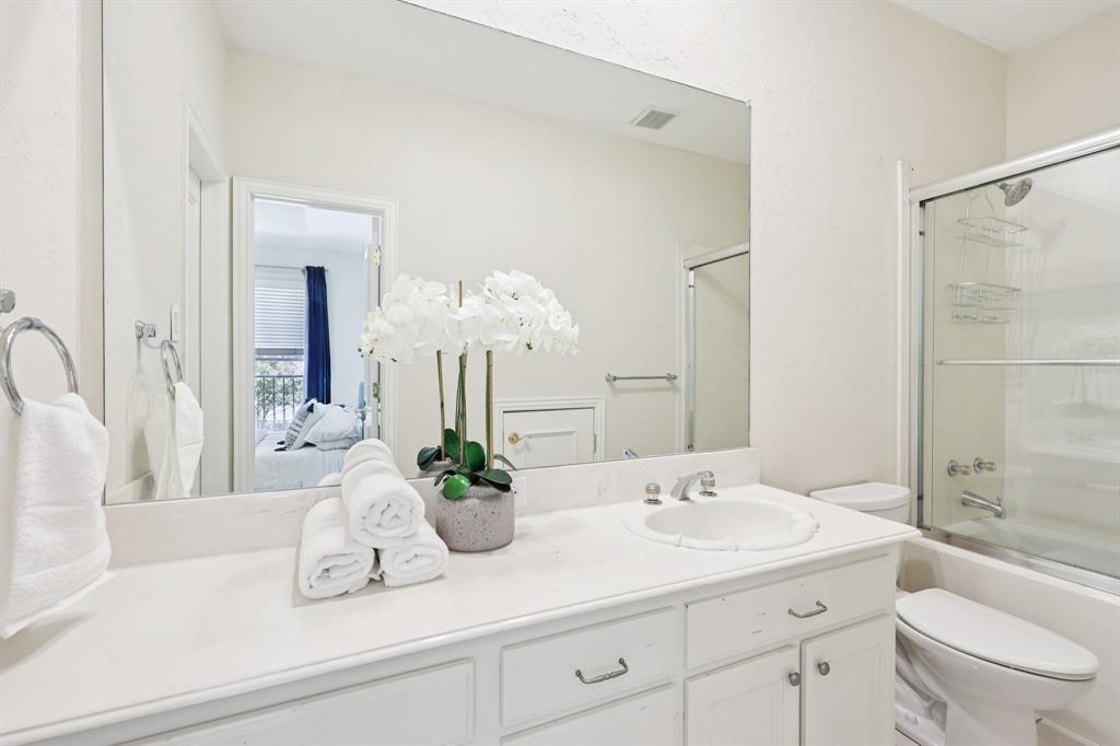 6065 Dilbeck Lane Dallas, TX 75240 - Photo 28 of 40 a bathroom with a sink a toilet and shower