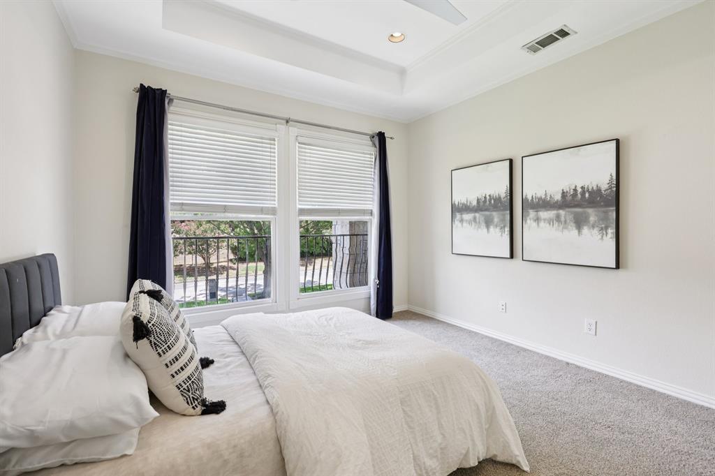 6065 Dilbeck Lane Dallas, TX 75240 - Photo 29 of 40 a bedroom with a bed and a large window