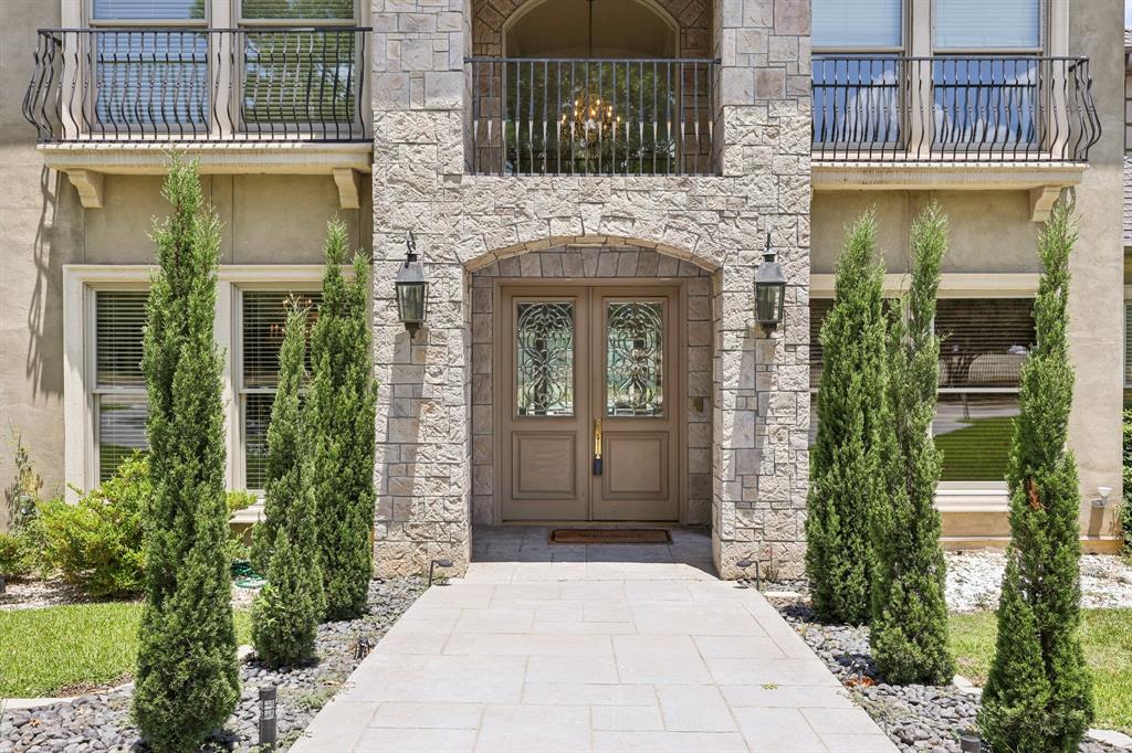 6065 Dilbeck Lane Dallas, TX 75240 - Photo 3 of 40 front view of a brick house with a large window