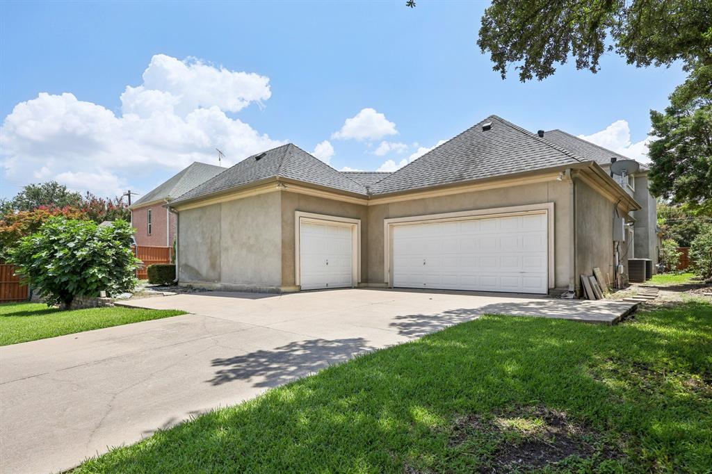 6065 Dilbeck Lane Dallas, TX 75240 - Photo 35 of 40 a front view of a house with a yard and garage