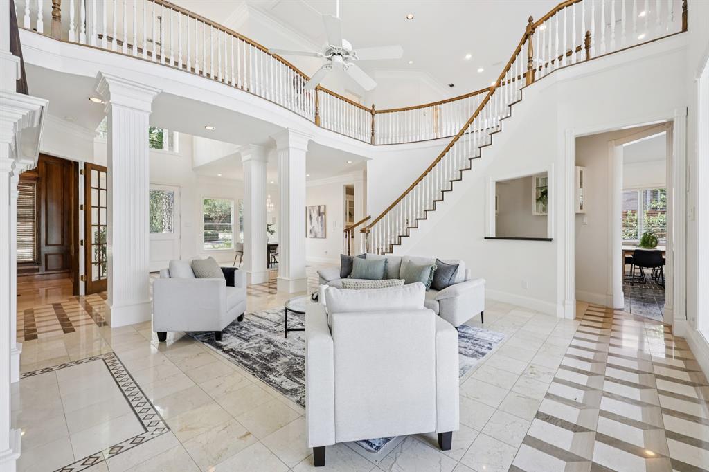 6065 Dilbeck Lane Dallas, TX 75240 - Photo 4 of 40 a living room with furniture and stairs