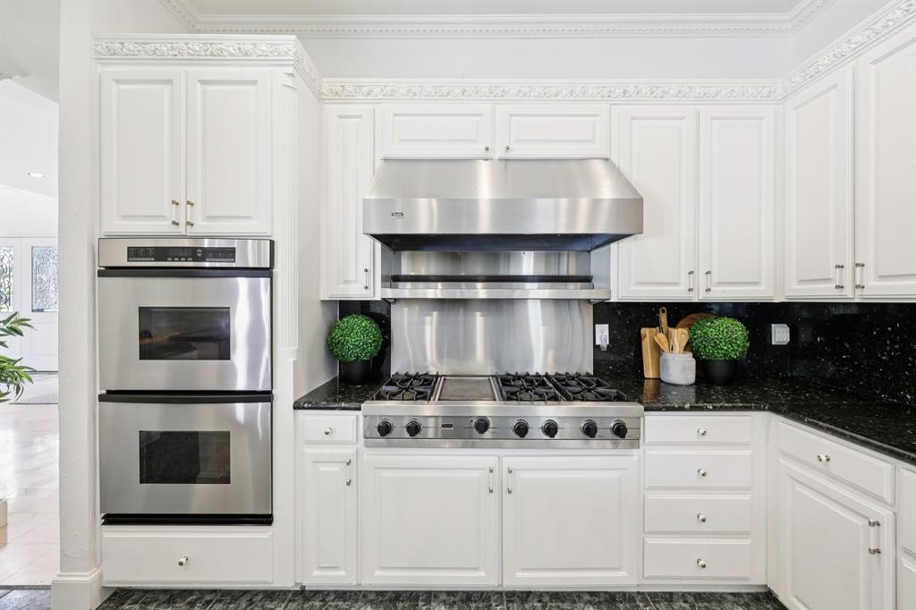 6065 Dilbeck Lane Dallas, TX 75240 - Photo 10 of 40 a kitchen with appliances cabinets and a window