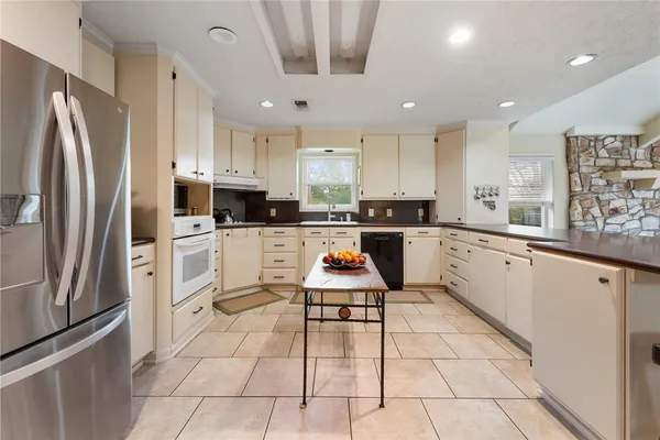a kitchen with cabinets and white stainless steel appliances