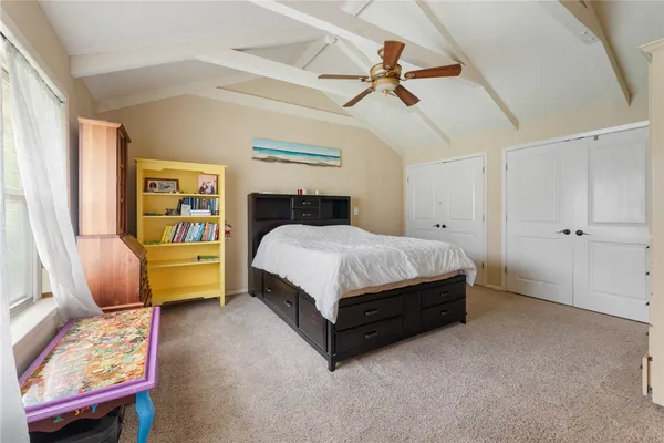 a bedroom with a bed chair and a window