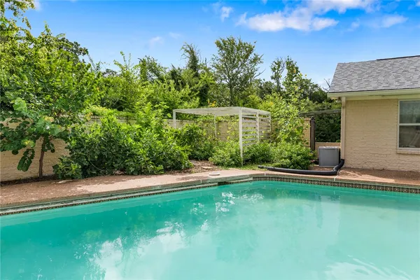 a view of a swimming pool with a yard