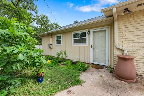 a view of a backyard with potted plants