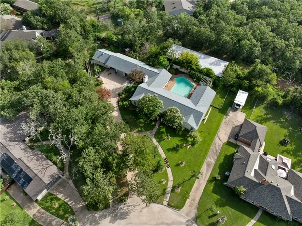 an aerial view of a house with a yard