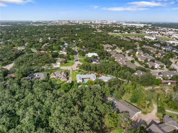 an aerial view of residential houses with city view