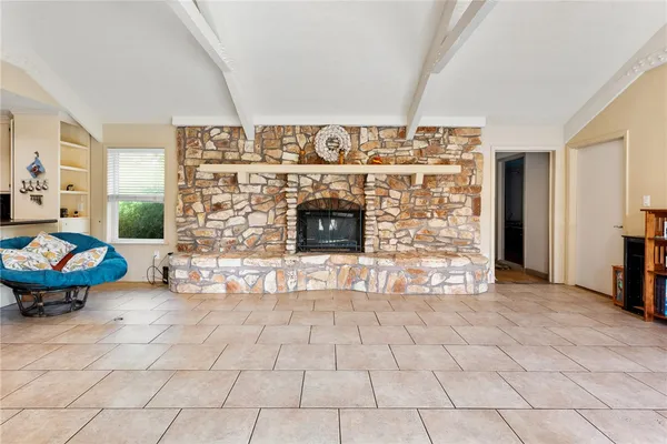 a living room with furniture a fireplace and a dining table
