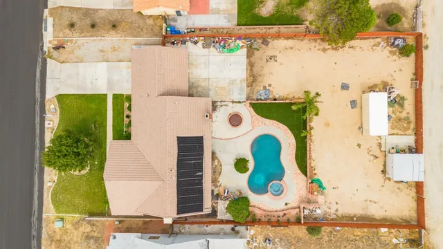 an aerial view of residential house with outdoor space and parking