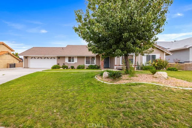a view of house with yard and outdoor seating