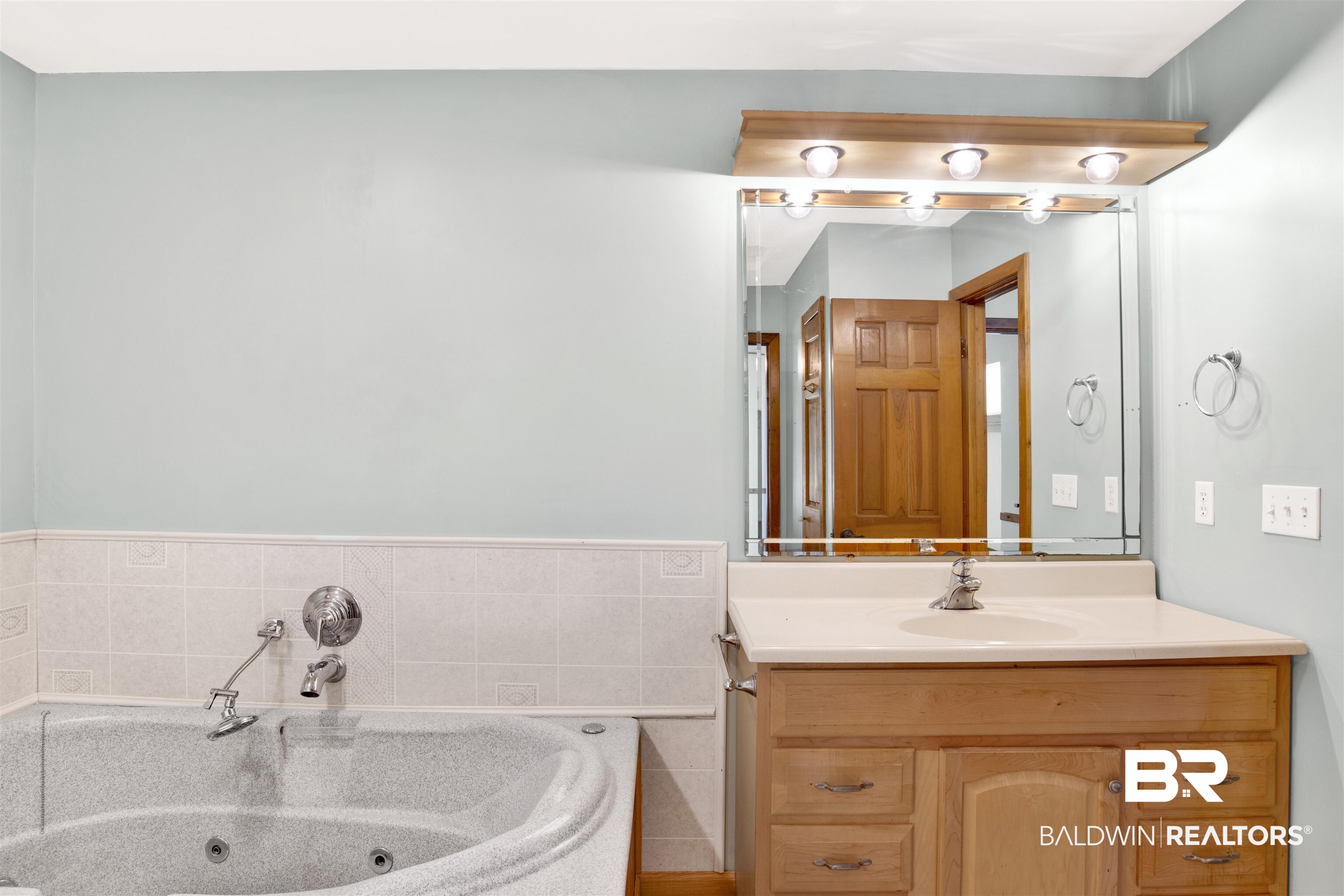 7411 Bay Road Mobile, AL 36605 - Photo 22 of 34 Bathroom with vanity, tile walls, and a tub with jets
