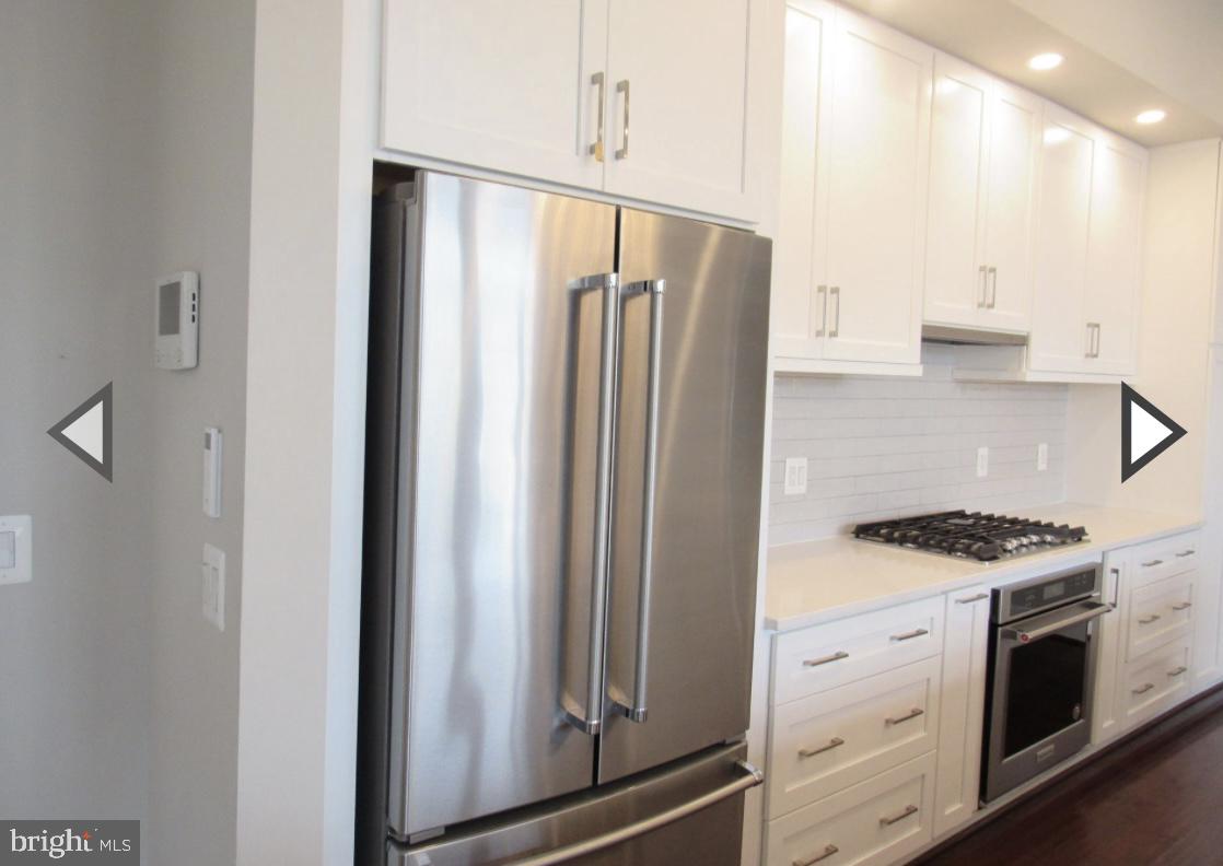 2 Stationmaster Street Southeast, Unit 302 Leesburg, VA 20175 - Photo 13 of 57 a kitchen with stainless steel appliances a refrigerator sink and cabinets