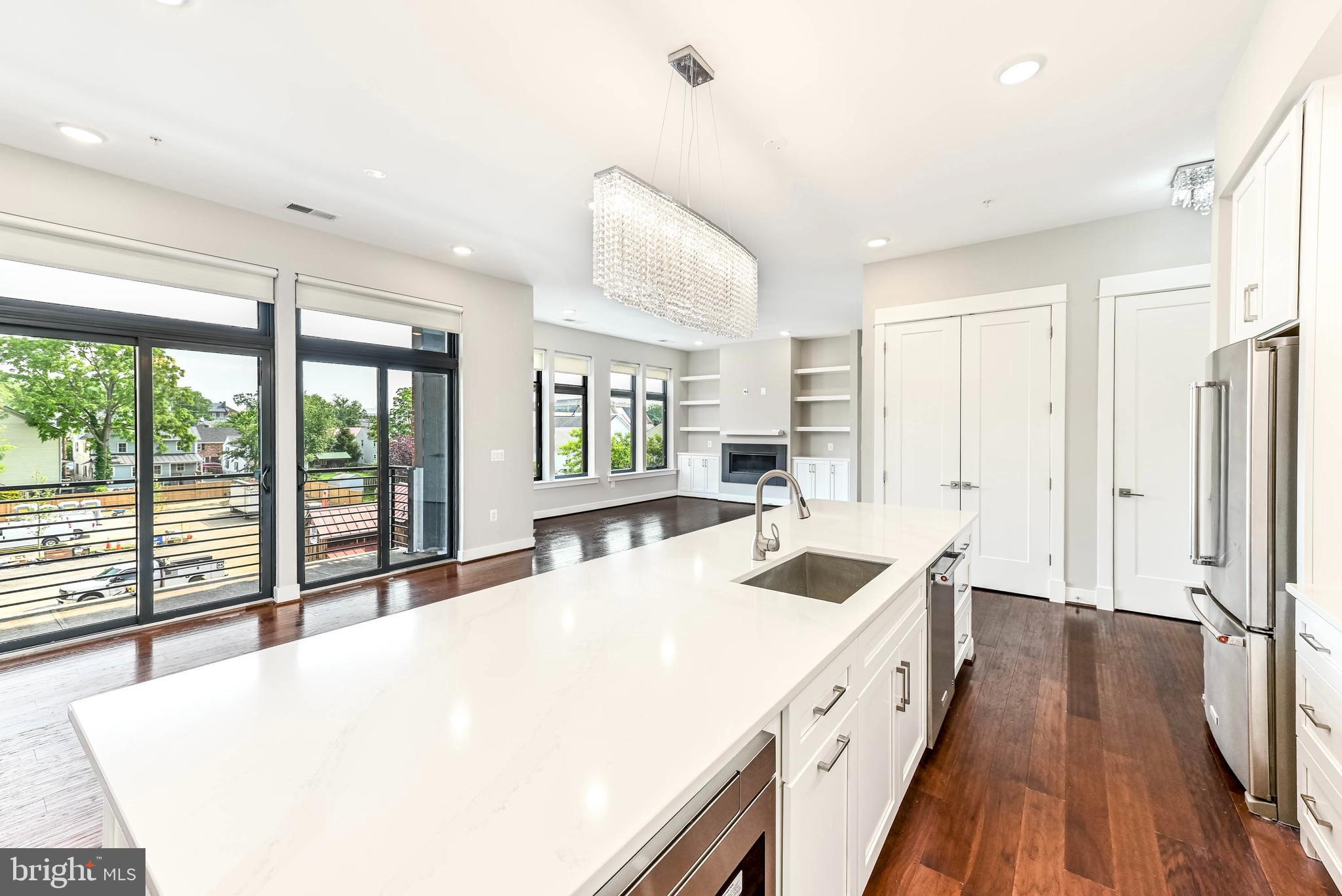 2 Stationmaster Street Southeast, Unit 302 Leesburg, VA 20175 - Photo 2 of 57 a large white kitchen with a large window