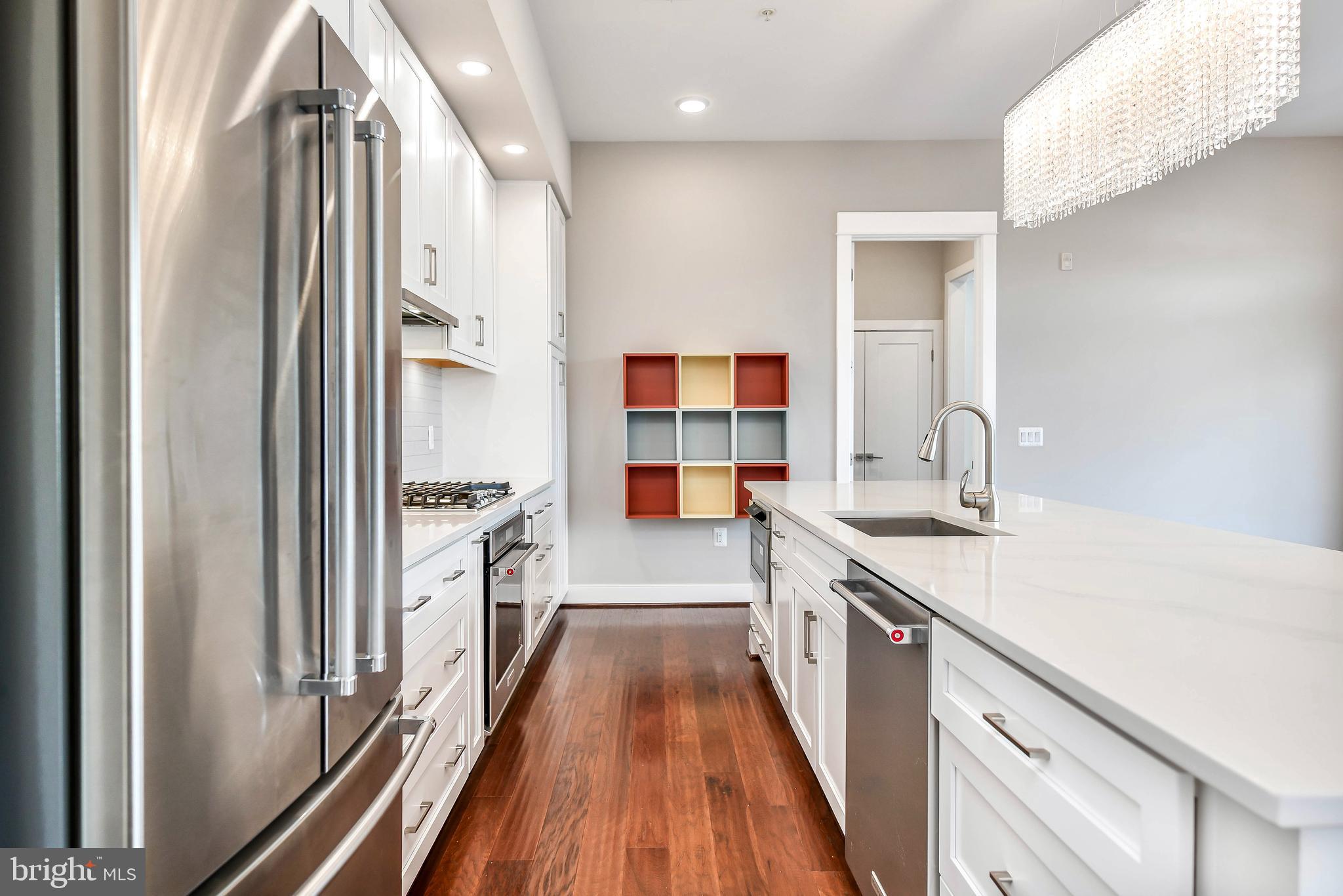 2 Stationmaster Street Southeast, Unit 302 Leesburg, VA 20175 - Photo 23 of 57 a kitchen with a sink and wooden floor