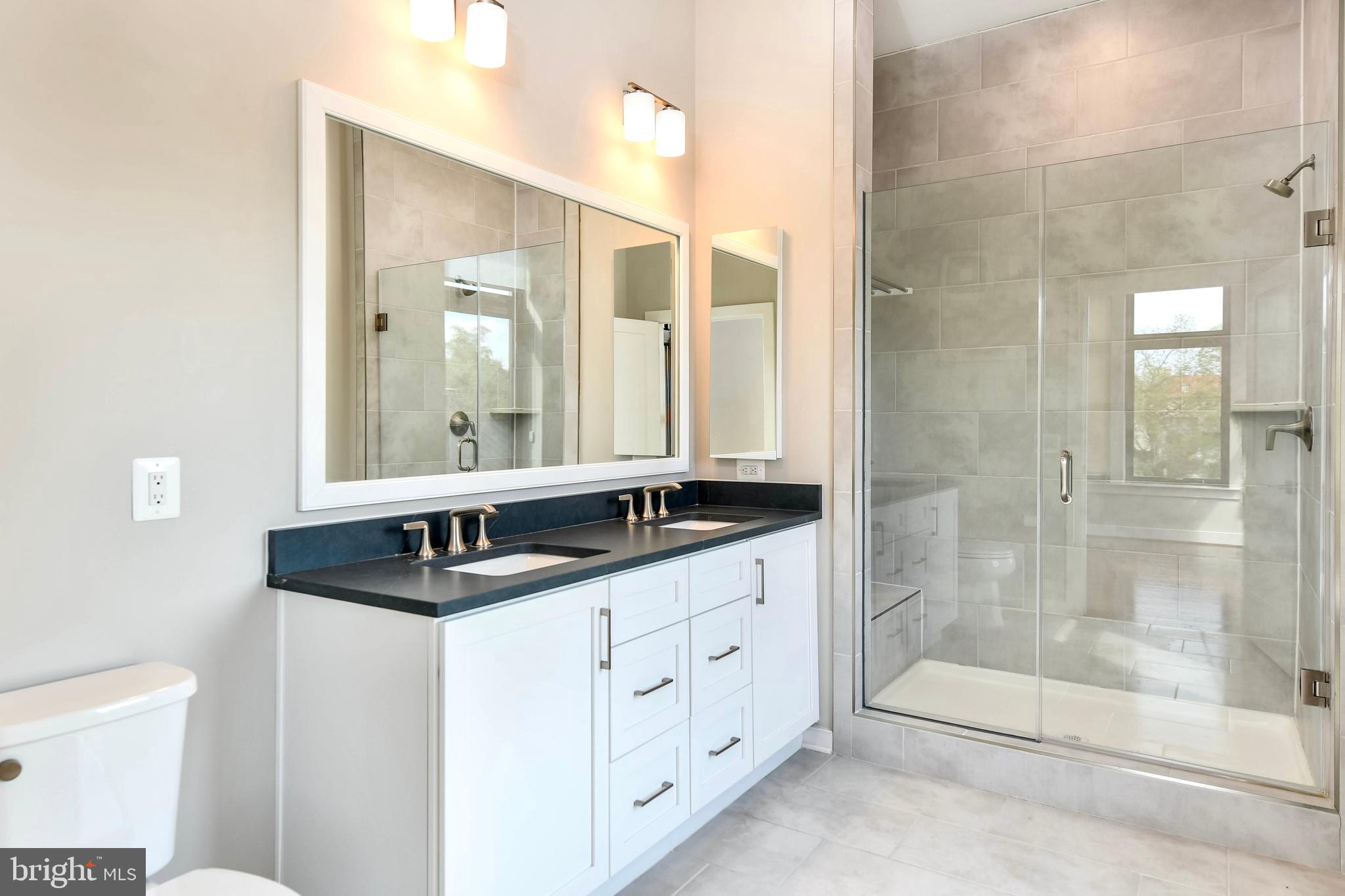 2 Stationmaster Street Southeast, Unit 302 Leesburg, VA 20175 - Photo 31 of 57 a bathroom with double sink and a mirror