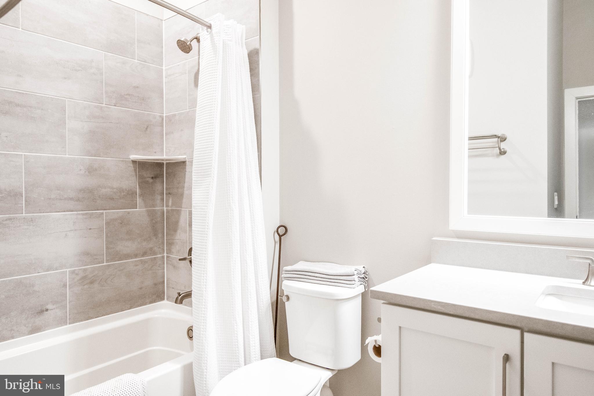2 Stationmaster Street Southeast, Unit 302 Leesburg, VA 20175 - Photo 33 of 57 a bathroom with a sink a toilet and shower