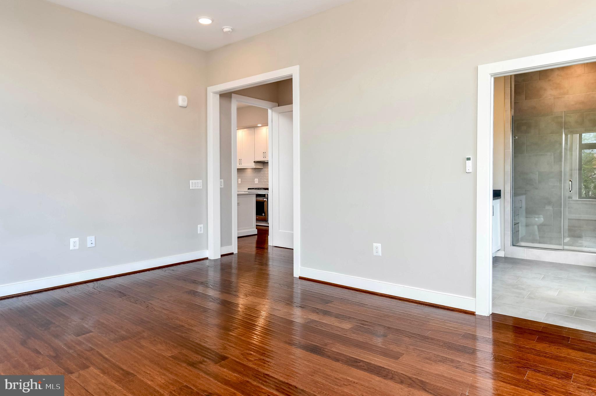 2 Stationmaster Street Southeast, Unit 302 Leesburg, VA 20175 - Photo 34 of 57 a view of an empty room with wooden floor and a bathroom