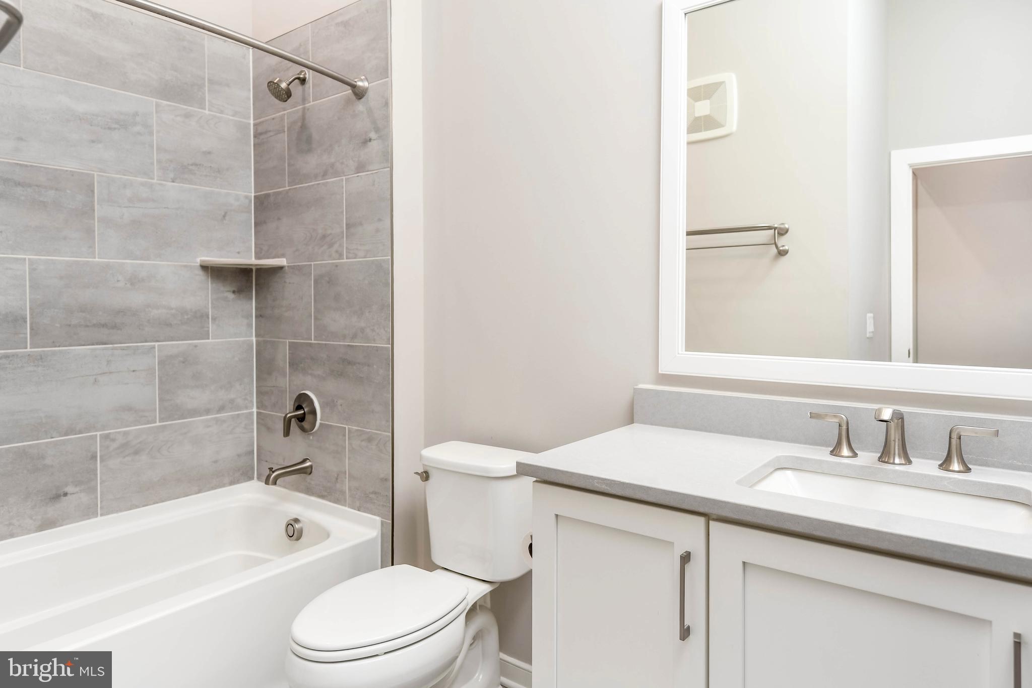 2 Stationmaster Street Southeast, Unit 302 Leesburg, VA 20175 - Photo 35 of 57 a bathroom with a sink a toilet and shower