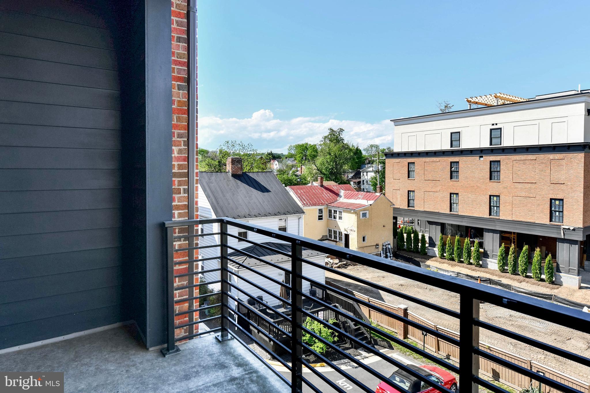 2 Stationmaster Street Southeast, Unit 302 Leesburg, VA 20175 - Photo 39 of 57 a view of a balcony with two chairs and a table