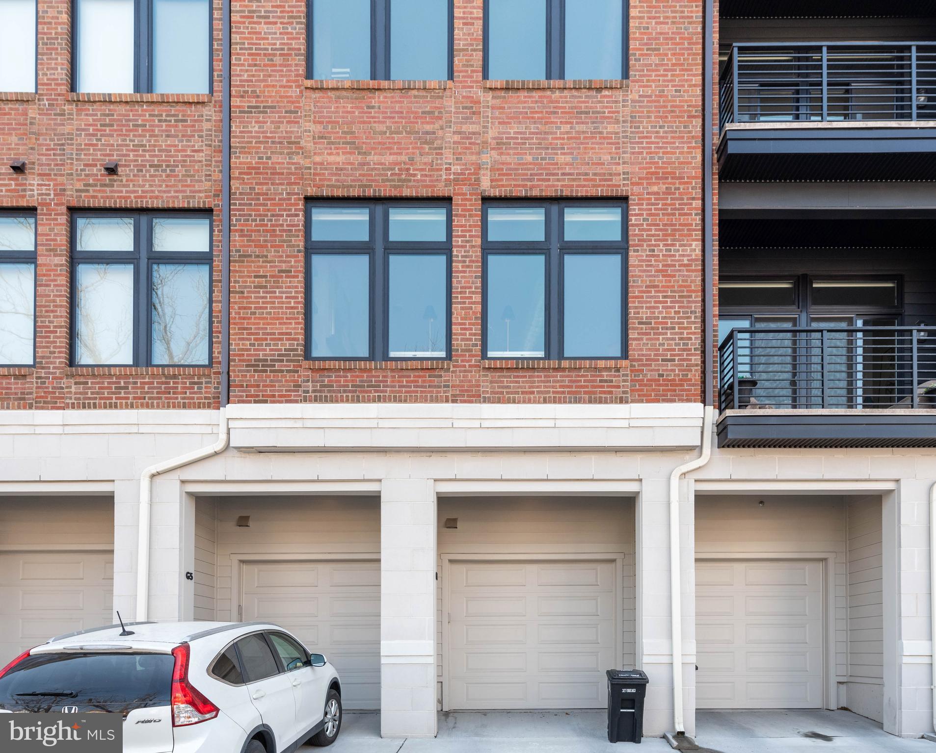 2 Stationmaster Street Southeast, Unit 302 Leesburg, VA 20175 - Photo 42 of 57 a front view of a building with a parking area