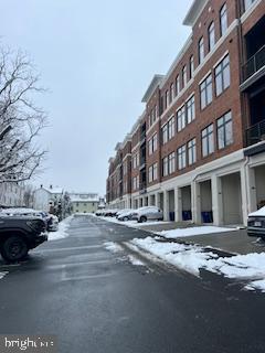 2 Stationmaster Street Southeast, Unit 302 Leesburg, VA 20175 - Photo 46 of 57 a city street lined with buildings and cars on road